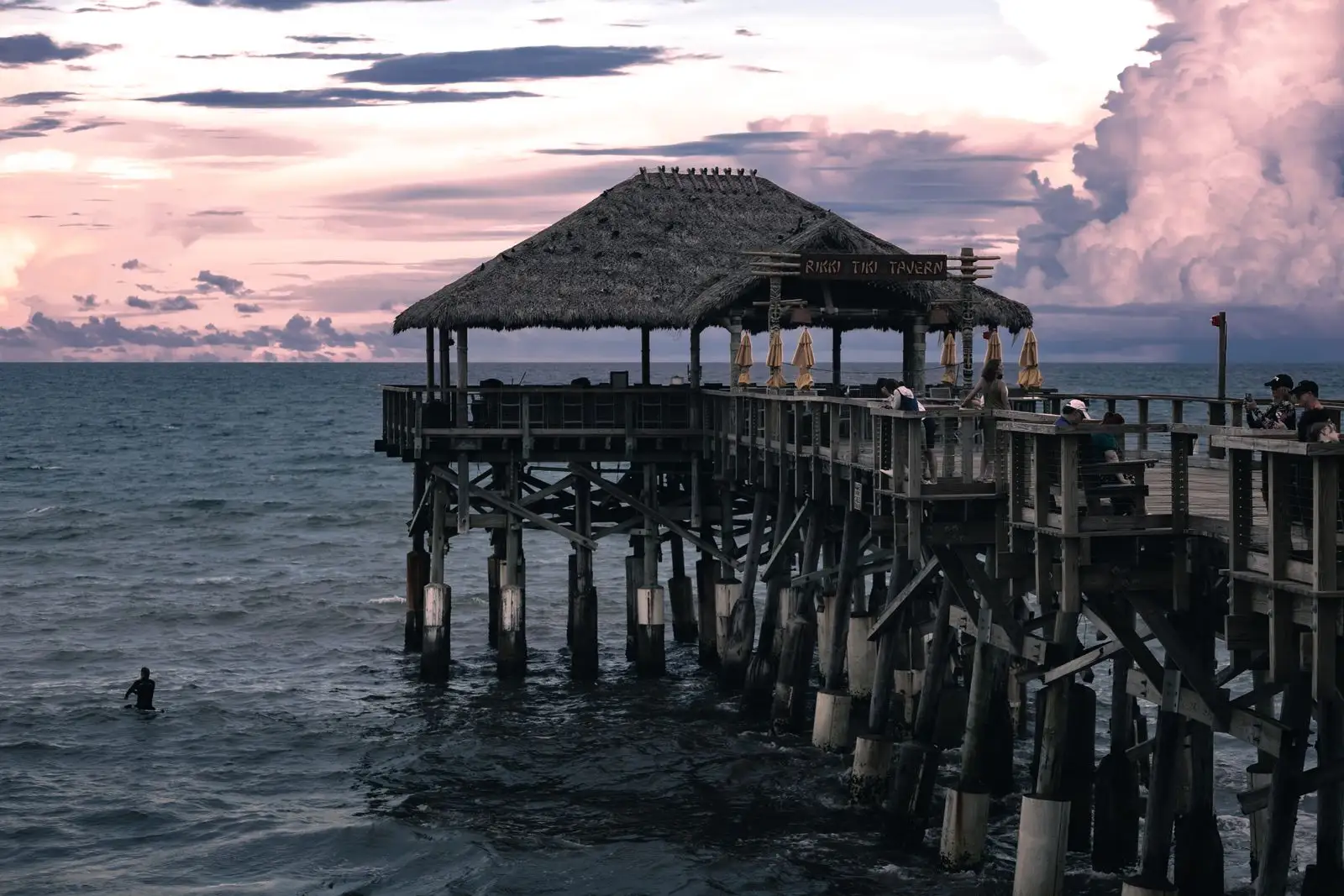 Cocoa Beach Pier and its thatched-roof deck at dusk